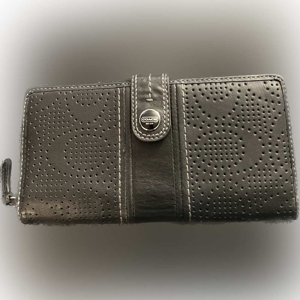 Black coach wallet with zipper pocket and snap closure.